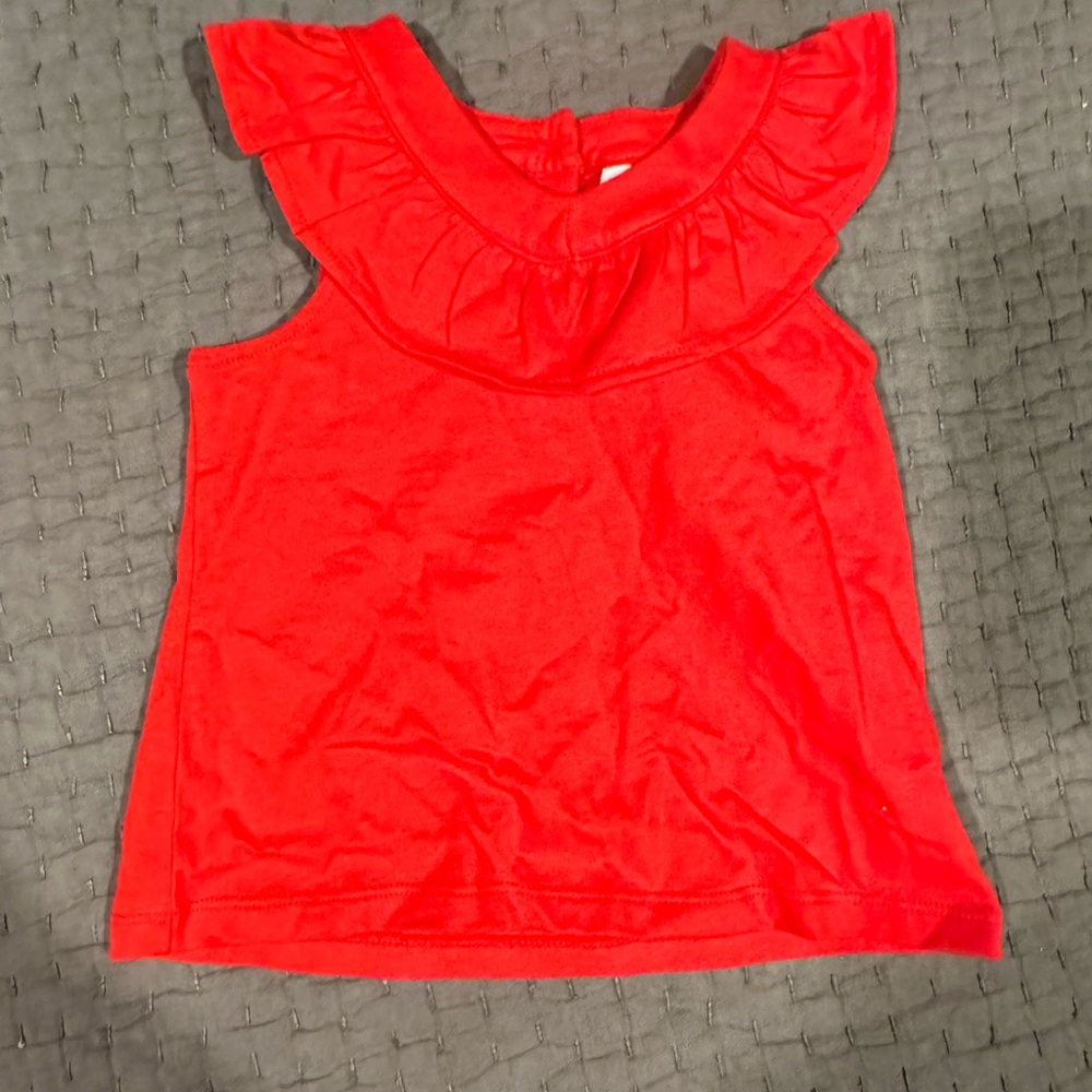 Red sleeveless shirt with ruffleneck